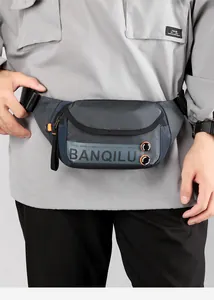 Close-up of grey-blue crosshatch fabric belt bag with orange zipper pull and logo detail