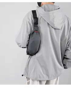 Detail of gray waterproof nylon chest bag featuring adjustable strap and buckle closure