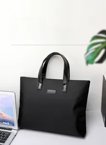 Business laptop bag with leather handles and nylon fabric in a minimalist office setting