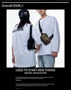 Trendy couple wearing olive and black mini crossbody chest bags in a streetwear style
