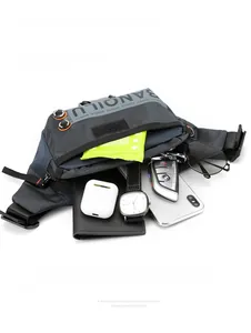 Detail view of multi-compartment navy and gray crossbody bag showing organized interior