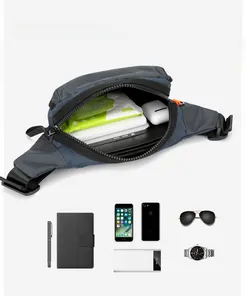 Internal capacity of large crossbody fanny pack showing phone, notebook and power bank