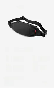 Detail view of black waterproof chest bag featuring adjustable strap and red side label