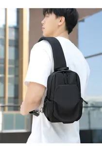 Outdoor lifestyle view of black Oxford fabric crossbody chest bag with wide strap