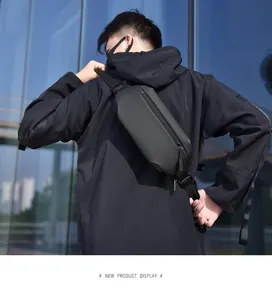 Outdoor close-up of a tactical black drop leg bag with water-resistant matte finish