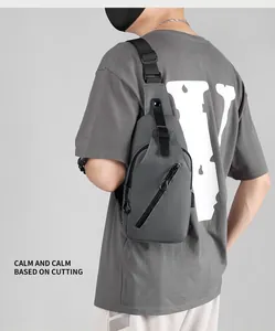 Waterproof dark grey men's crossbody chest bag worn by model showing outdoor utility style