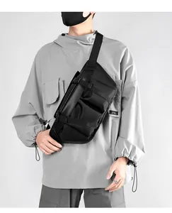 Close-up of black tactical chest bag showing functional buckles and webbing on oxford cloth