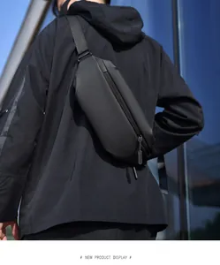 Rear view of model wearing a black tactical thigh bag in a modern urban setting