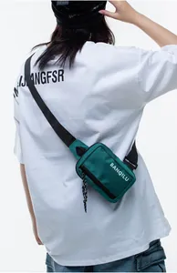 Close-up of dark green nylon phone bag with adjustable strap and BANQILU logo