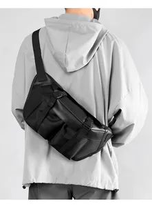 Close-up of black tactical oxford chest bag worn on back over grey hoodie jacket