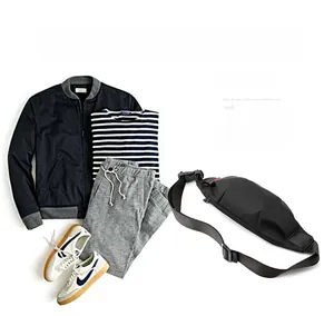 Black waterproof men's crossbody bag styled with trendy casual outfit and sneakers