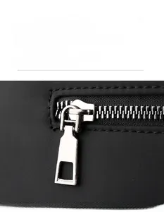 Close-up of smooth silver metal zipper on a black durable fabric business briefcase