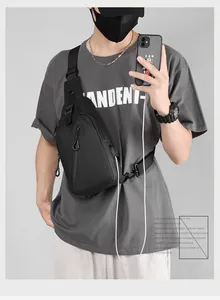 Men's waterproof black chest bag with built-in USB charging port for mobile devices