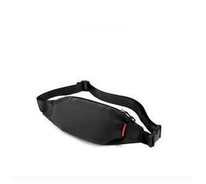 Side view of black waterproof nylon crossbody bag showing thickness and adjustable strap