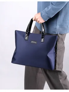 Detail of navy blue business briefcase with durable waterproof fabric and leather handles