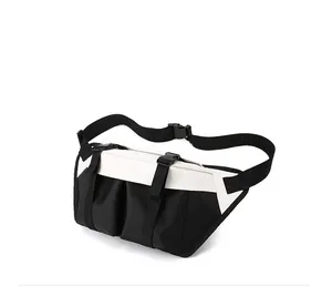 Detail view of adjustable strap and plastic buckles on a black and white crossbody bag