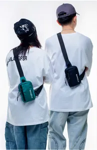 Detail of couple sports crossbody bags with BANQILU logo in green and navy blue nylon