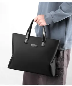 Detail of waterproof nylon business tote bag with reinforced handles and sleek matte finish