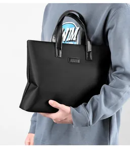 Detailed view of black business briefcase with leather handles and matte nylon texture