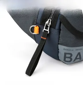 Detailed close-up of smooth metal zippers and blue checkered fabric on men belt bag