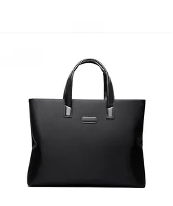 Front view of black waterproof nylon briefcase with dual handles and smooth finish