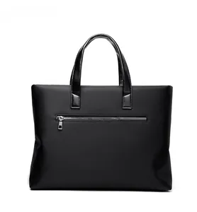 Detail view of the back of a black business laptop bag showing a zipper pocket