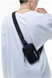 Detail showing the adjustable black shoulder strap and durable navy blue fabric texture