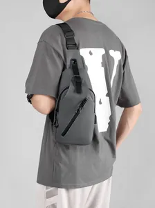 Close-up of a grey waterproof chest bag with matte finish and adjustable nylon shoulder strap