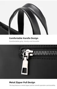 Detail of ergonomic leather handle and smooth metal zipper on black business laptop bag
