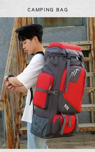 Side view of large 90L red and grey hiking backpack showing ergonomic design on stairs