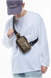 Close-up of khaki nylon crossbody bag with adjustable strap and BANQILU logo