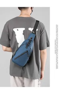 Close-up of blue water-resistant chest bag with USB port and adjustable shoulder strap