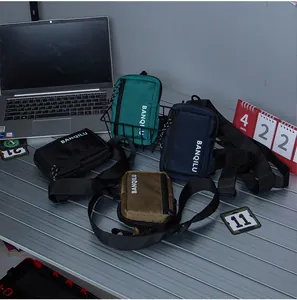 Detailed view of four compact nylon crossbody bags in green, navy, black and khaki