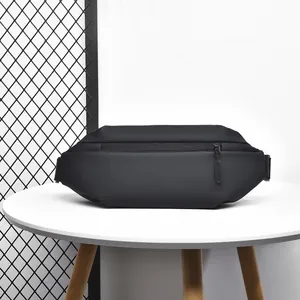 Detail of waterproof matte black tactical leg bag with zipper on a modern table