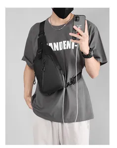 Close-up of black waterproof crossbody bag with integrated USB charging port and phone