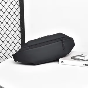 Close-up of a matte black tactical leg bag with water-resistant fabric on a minimalist display
