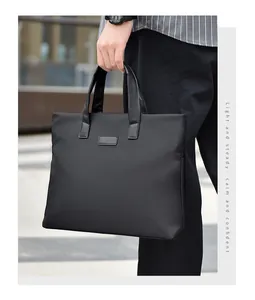 Close-up of minimalist black business briefcase with ergonomic handle and matte finish