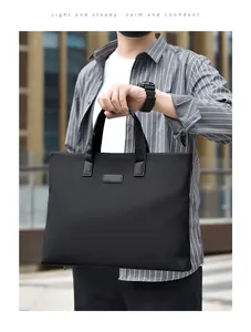 Close-up of man holding a sleek black professional business briefcase for men