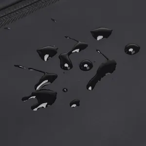 Macro shot of waterproof black fabric with water droplets on tactical leg bag surface