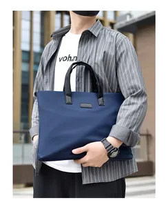 Detail of navy business briefcase showing premium waterproof nylon and leather handles