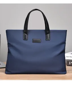 Detail of dark blue waterproof nylon business briefcase with black leather handles and trim