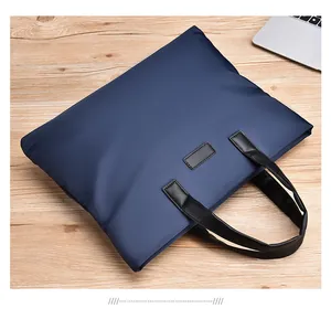 Close-up of navy blue waterproof nylon business briefcase with black leather handles