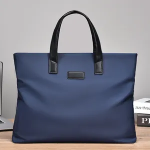 Large capacity men's business briefcase in navy nylon with leather handles on desk