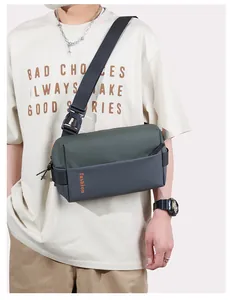 Detail of army green and grey crossbody bag with fashion print and adjustable strap
