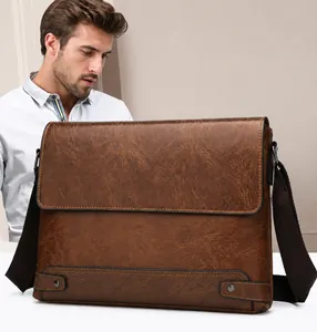 Close-up of brown faux leather briefcase with textured finish and adjustable shoulder strap