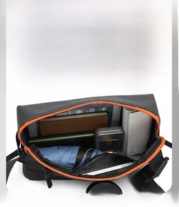Internal storage detail of black crossbody bag with orange zipper and large capacity