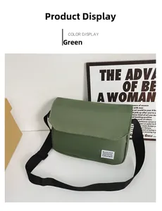 Detailed close-up of a green canvas messenger bag with a Black Rice label and black strap
