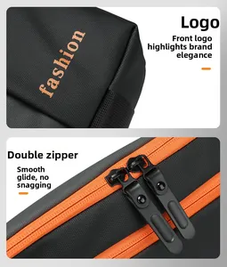 Detail view of smooth metal double zippers and orange fabric on black nylon bag
