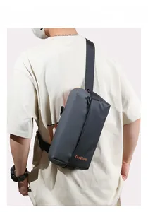 Men's crossbody chest bag in dark gray tech fabric featuring orange fashion lettering