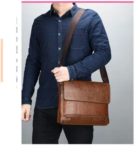 Detailed view of brown vintage leather briefcase with adjustable nylon shoulder strap